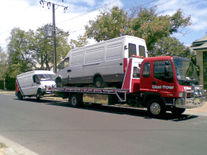 Two vans being towed locally