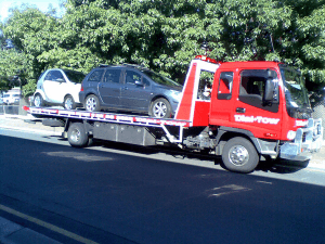 Two cars being towed