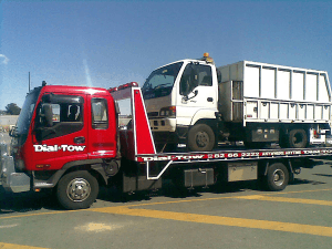 A rubbish truck, that broke down while on job, being towed to the repair workshop