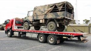 Dial-a-Tow assisting Australian army with towing of army truck using a tilt truck from its fleet