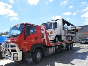 A burnt out truck loaded on to our tilt truck for interstate towing to a repair workshop