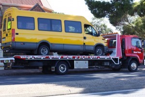 Transporting a school bus locally to a repair workshop