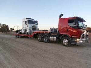 Towing a heavy vehicle part across the borders on our low-bed tilt trucks