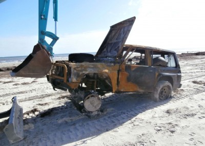 A front end loader with caterpillar tracks had to be used to access the vehicle to be recovered because of the soft sand